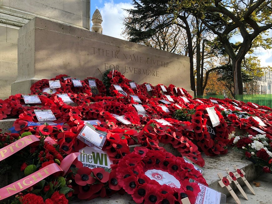 Poppy wreathes placed on Southampton Cenotaph in Watts park. Two of the nearest wreaths say they are from the Women's Institute and Hampshire & Isle of Wight Fire & Rescue Service. The monument's inscription reads "Their name liveth for evermore."