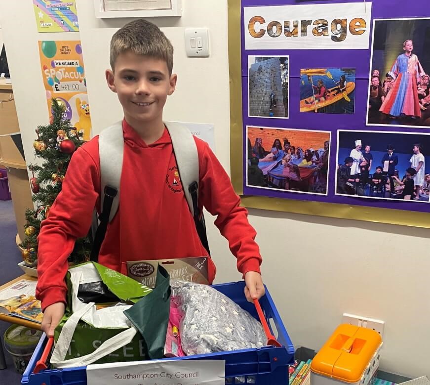 Year 6 pupil George with toy donations he organised at school