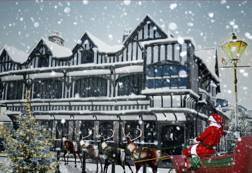 Santa on his sleigh outside snowy Tudor House
