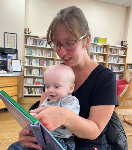 Karen and baby Andy reading a book