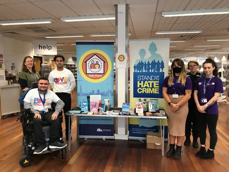 A group of people in Shirley library publicising Love Don't Hate, Safe Places and Stand up to Hate Crime