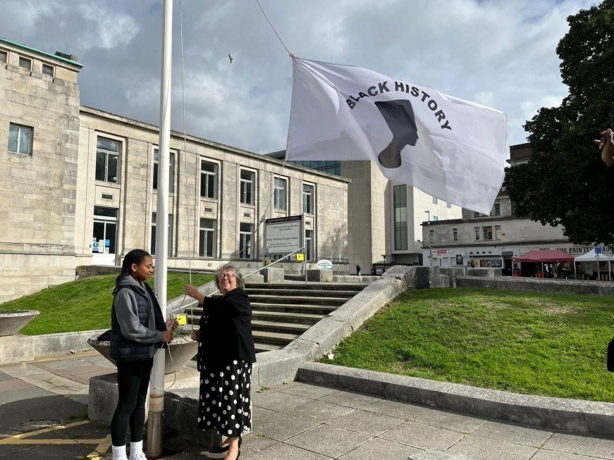 The Right Worshipful Lord Mayor of Southampton, Councillor Jacqui Rayment and another person raising the Black History Month flag at Southampton Civic Centre