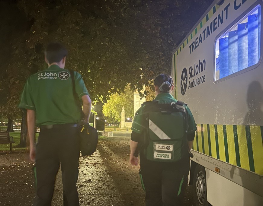 Two members of St John ambulance beside a treatment vehicle