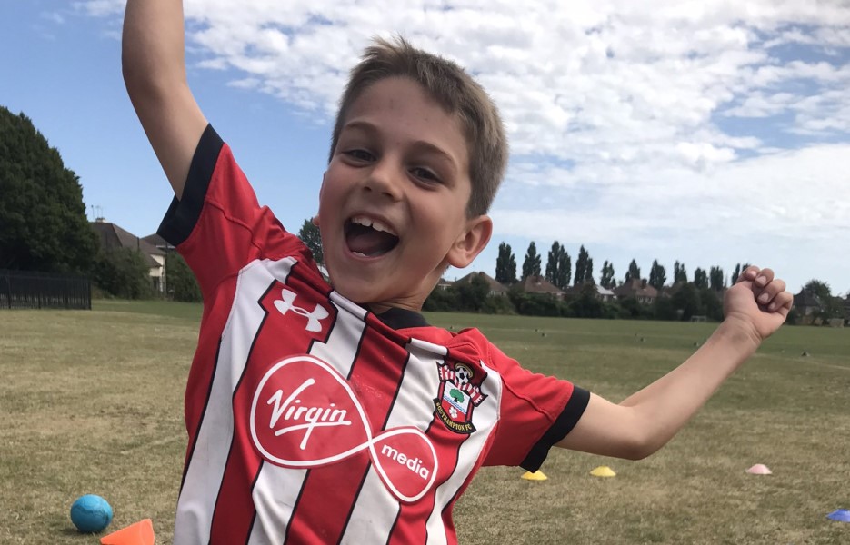 A happy child in a Southampton FC football shirt
