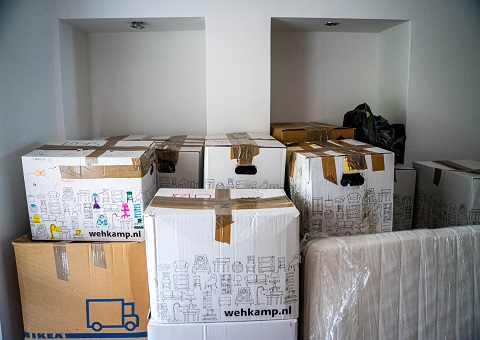 Moving boxes piled up in a room