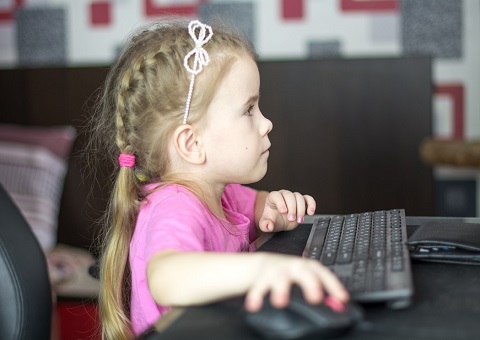 A girl sitting at a computer