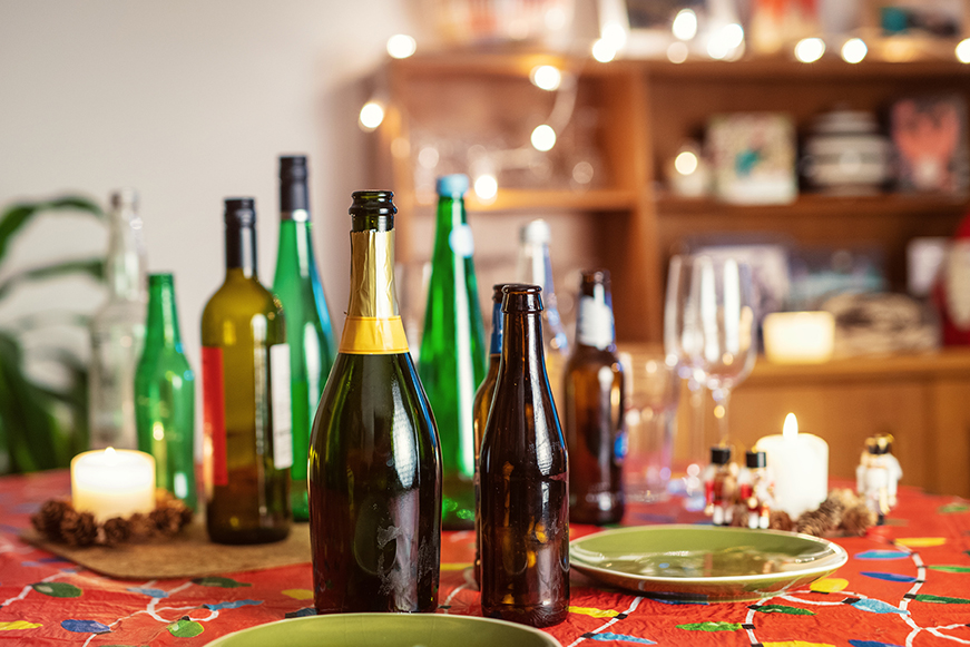 A Festive Dinner Table Ladened With Empty Drink Bottles