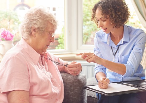 Two women discussing a Careline device