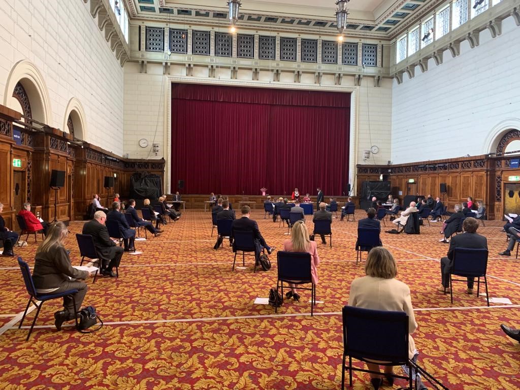 Attendees of the Southampton City Council 2021 annual general meeting, sitting in the guildhall, observing social distancing.