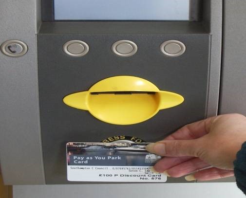 Holding card against machine Holding card against machine