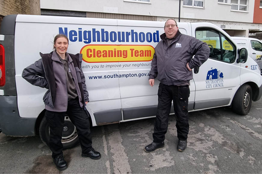 Two cleaning supervisors posing with a Neighbourhood Cleaning Team van Two cleaning supervisors posing with a Neighbourhood Cleaning Team van