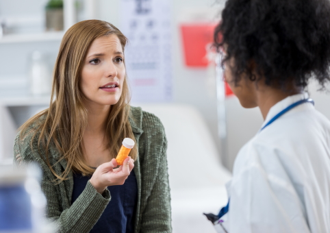 Woman talking to medical practitioner