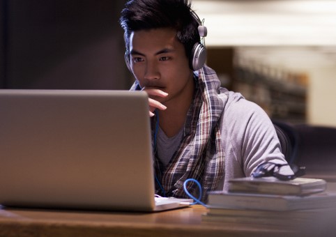 Young person looking at a laptop