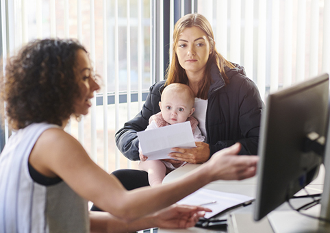 Person giving advice to a mother and child