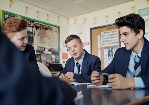 Secondary school children sitting at desks