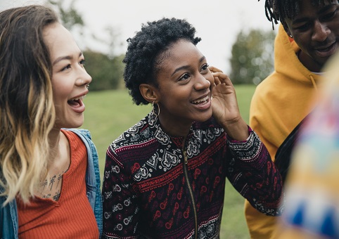 A group of young friends laughing in a park