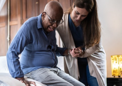 Carer helping a man