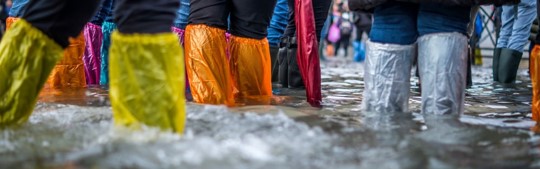 People walking through a flood