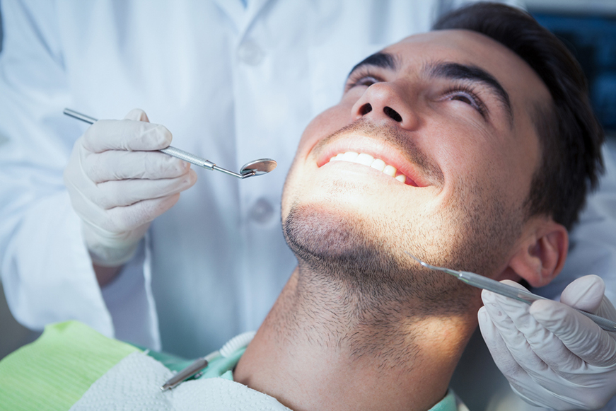 A man receiving a dental examination A man receiving a dental examination