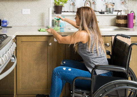 Person in a wheelchair cleaning kitchen 