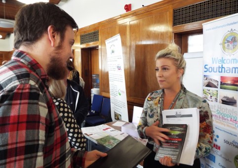 Exhibitor speaking to an attendee at a jobs fair
