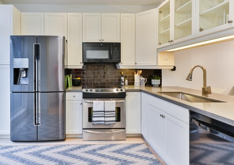 Kitchen with fridge, oven, microwave and sink