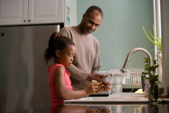 Adult and child in a kitchen