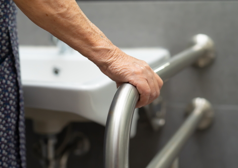 Woman holding on to bar in bathroom