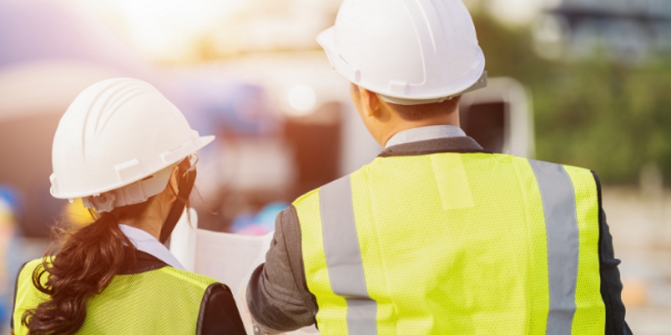 Image Of Two People Wearing Hard Hats And High Vis Jackets