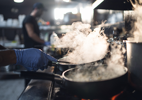 Pans on a hob with smoke