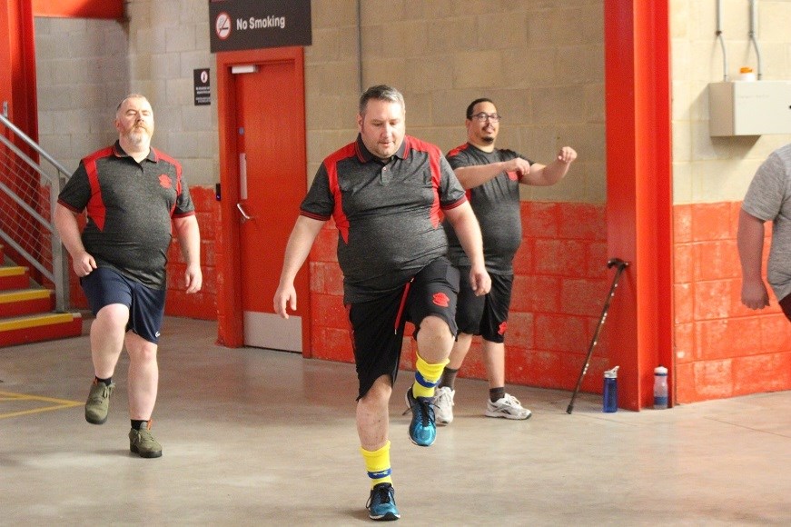 Three men warming up in exercise gear