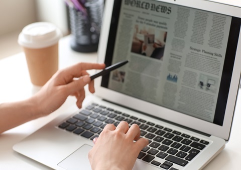 Newspaper on a laptop screen