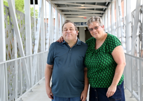Two people posing on a footbridge
