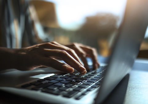 Someone typing on a laptop keyboard