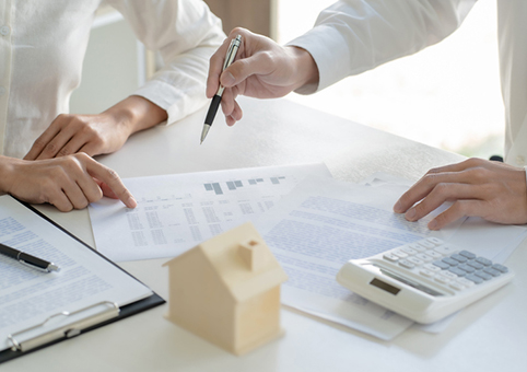 Two people looking over a bill with a calculator