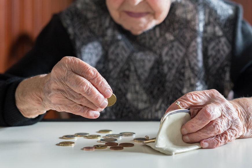 An Elderly Person Counting Coins From Their Purse An Elderly Person Counting Coins From Their Purse