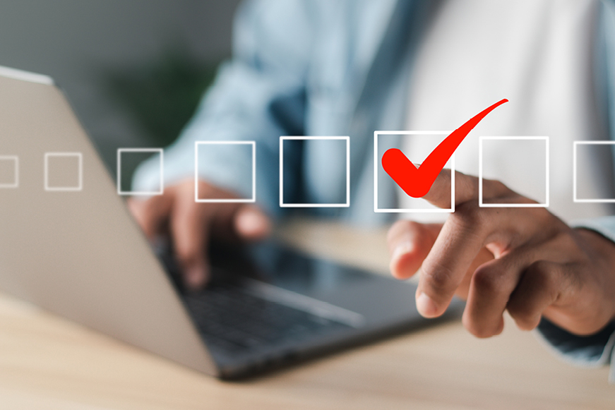 Someone On A Laptop, With Their Finger Tapping A Checkbox