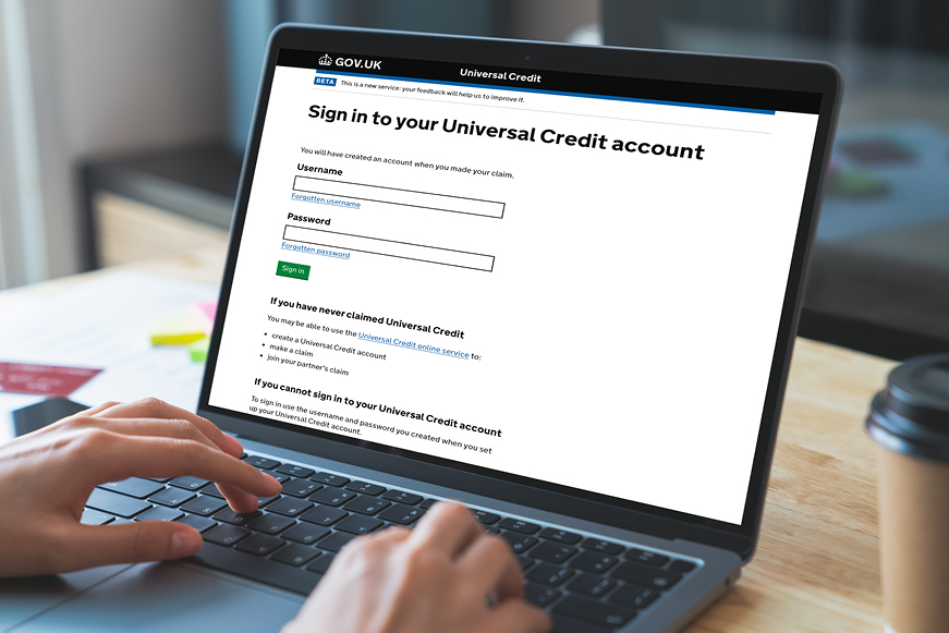Someone on a laptop where the screen shows "Sign in to your Universal Credit account" Someone on a laptop where the screen shows "Sign in to your Universal Credit account"