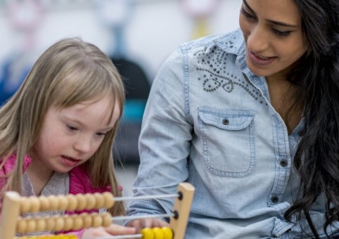 Child with an adult using an abacus