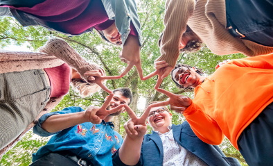 A group of people making the shape of a star with their hands