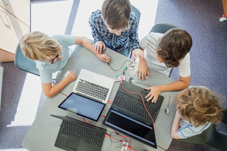 A group of children using laptop computers