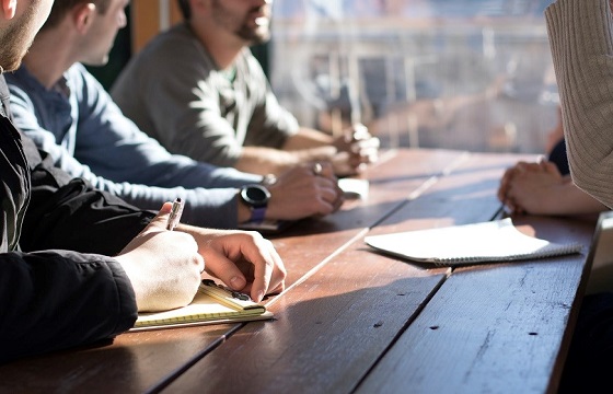 Young business people gathered around a table