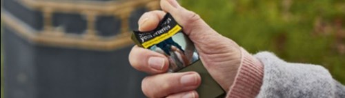 Hand crushing cigarette packet