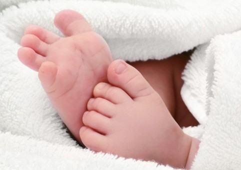 Baby feet surrounded by a blanket