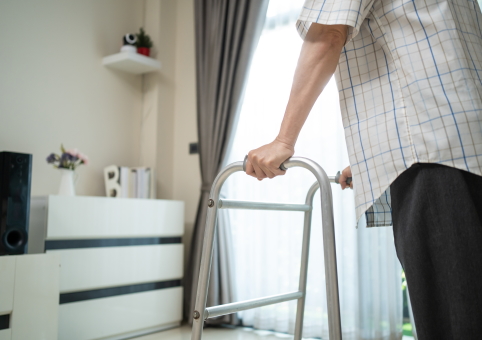 Man using ZImmer frame in house