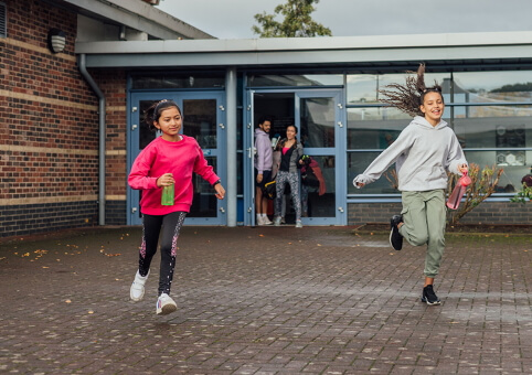 Children running outside school