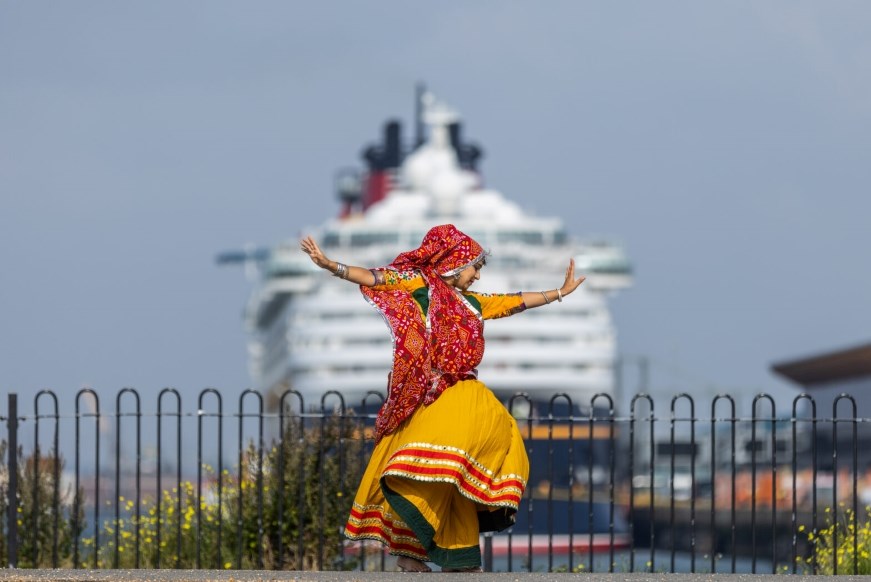 Mela dancer in front of cruise ship