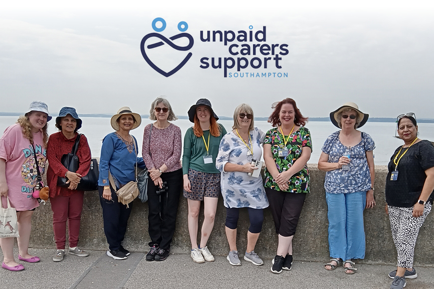 Nine women posing for a photograph with text "Unpaid Carers Support Southampton" Nine women posing for a photograph with text "Unpaid Carers Support Southampton"