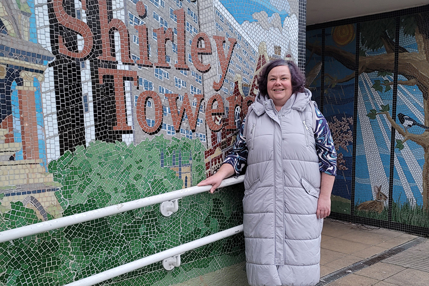 Smiling Female Tenant Next To Sign Of Shirley Towers