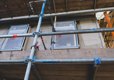 Building with scaffolding and windows being installed